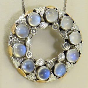 large 1930s floral wreath pendant with blue moonstones in sterling and 14k.JPG