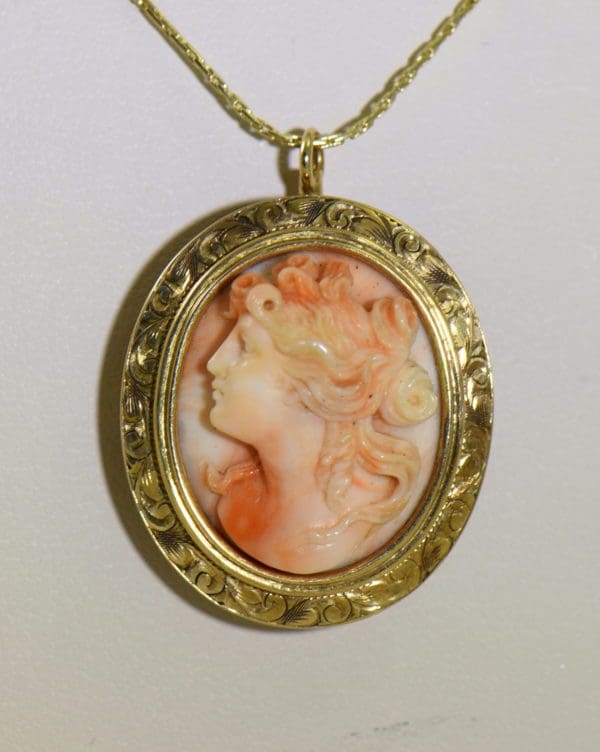 antique carved angel skin coral cameo high relief face in engraved yellow gold frame.JPG