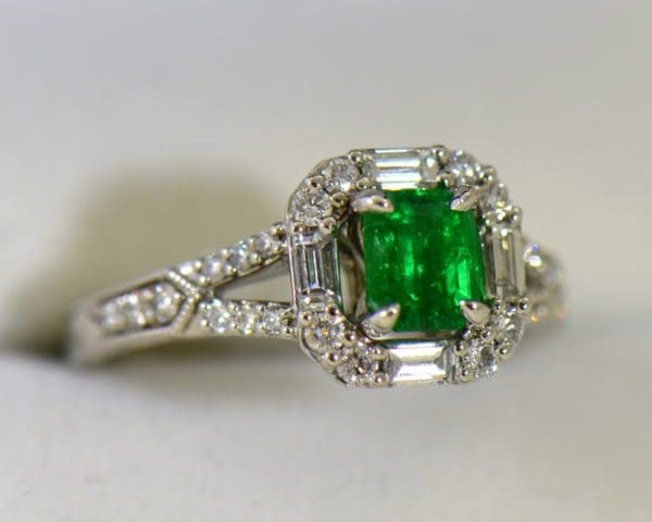 radiant cut natural emerald in baguette diamond halo engagement ring