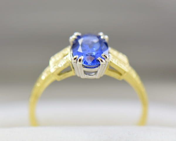 art deco yellow gold engagement ring with oval blue sapphire