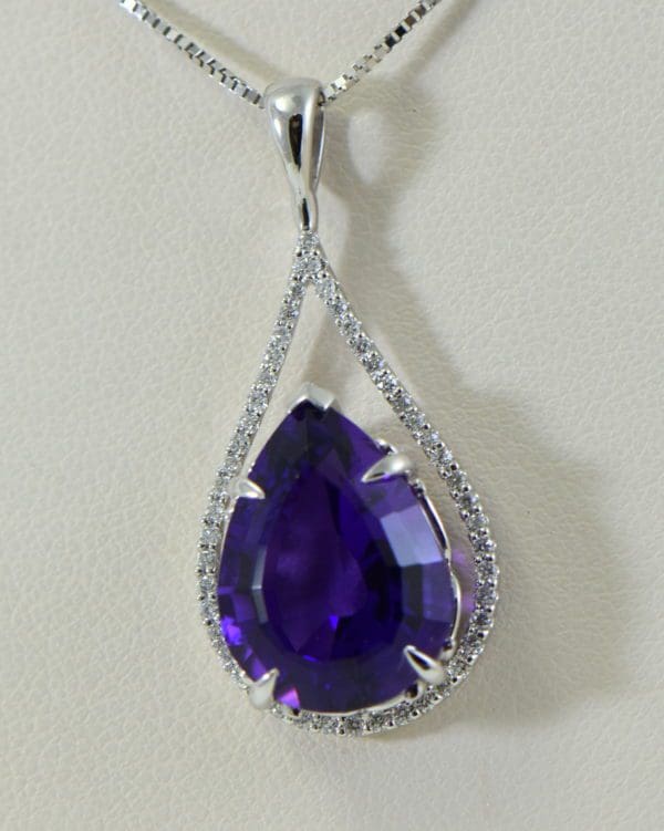 siberian amethyst pear shape set into diamond frame pendant.JPG