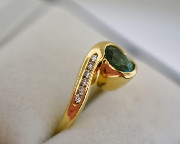 custom 18k yellow gold swirl ring with bezel set teal tourmaline 2