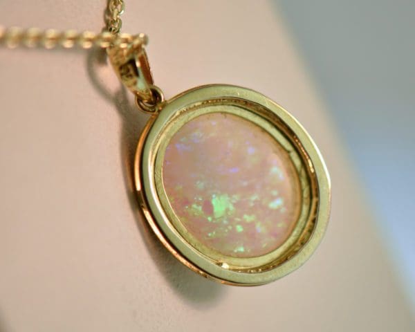 large oval australian crystal opal pendant in yellow gold bezel 2