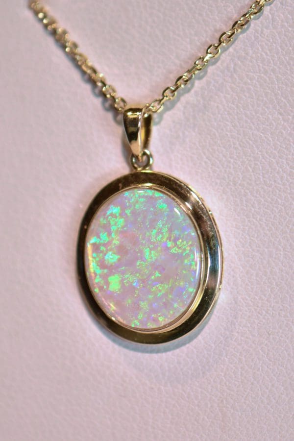 large oval australian crystal opal pendant in yellow gold bezel 3