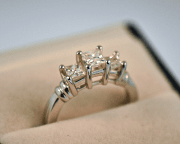 platinum three stone ring with princess cut diamonds