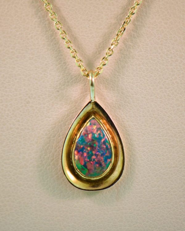 vintage gold pendant bezel set with gem grade black opal