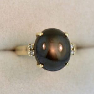 large black star sapphire ladies ring yellow gold