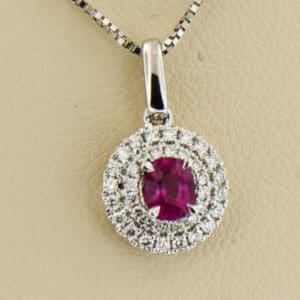 classic ruby and diamond double halo pendant