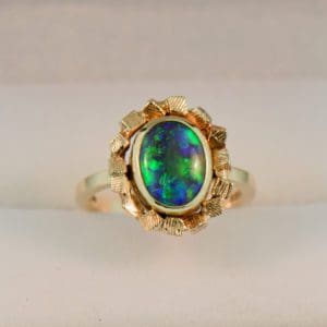 mid century gold and black opal bezel set solitaire engagement ring