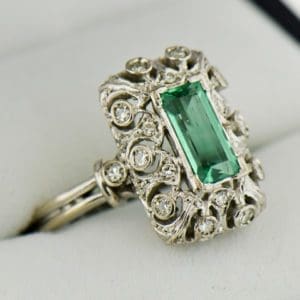 vintage platinum ring with filigree diamonds and elongated emerald