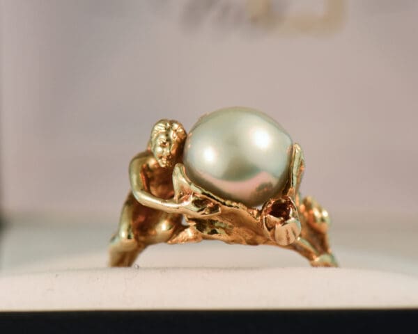 carved artsy gold ring with pixie or sprite holding pearl 3