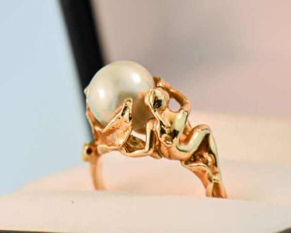 carved artsy gold ring with pixie or sprite holding pearl 4