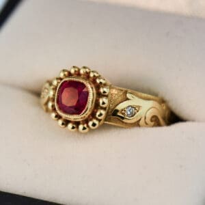custom carved gold band style ring with bezel set jedi red spinel