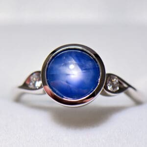 custom round burmese blue star sapphire bezel set engagement ring