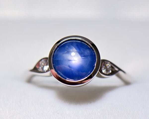 custom round burmese blue star sapphire bezel set engagement ring