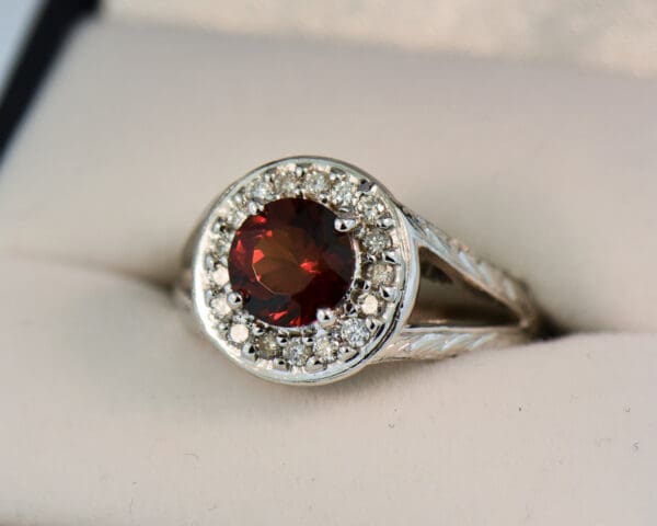 red hessonite garnet and diamond halo ring with carved design